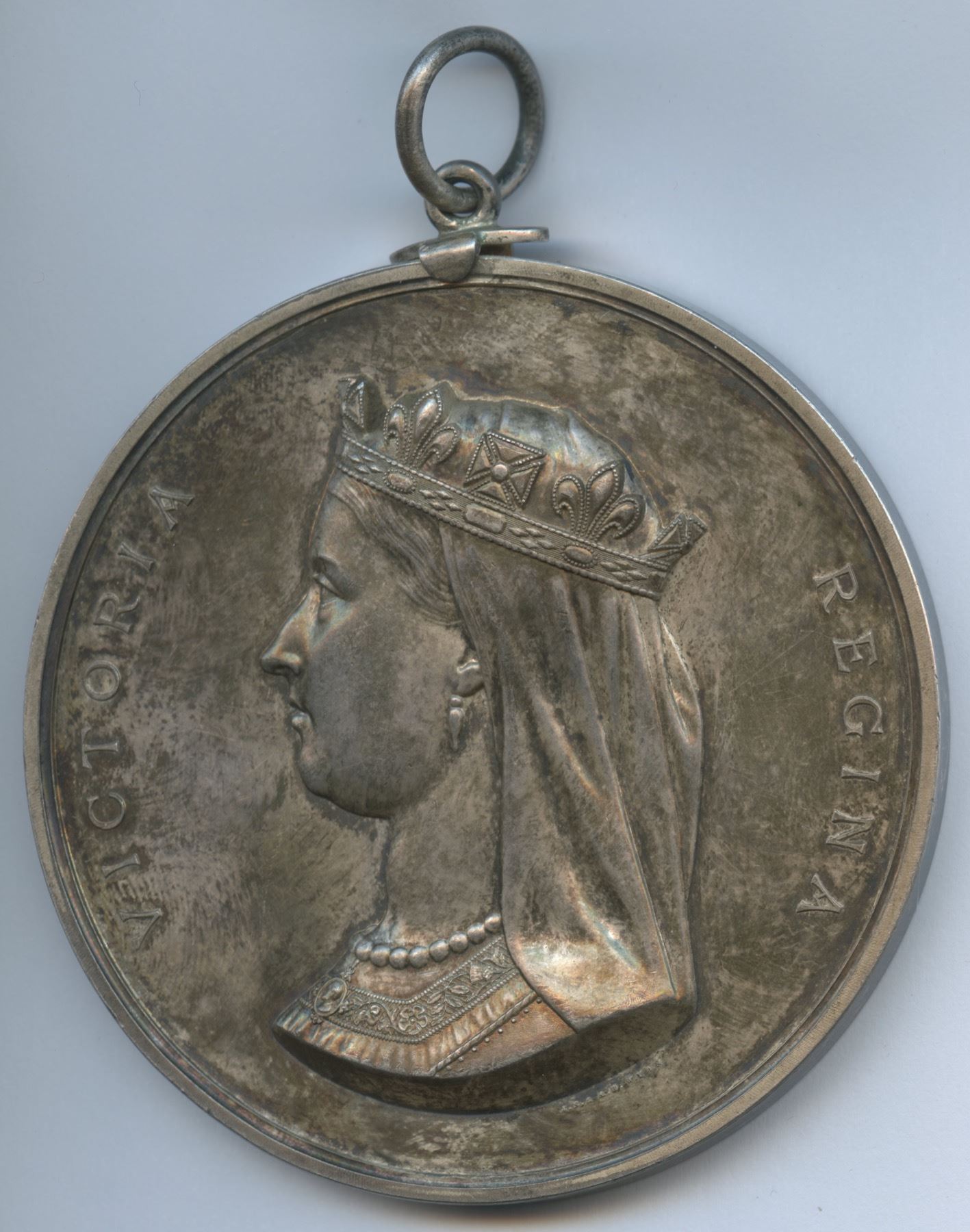 Full original photograph of the Treaty 6 medal's Queen Victoria portrait face and suspension